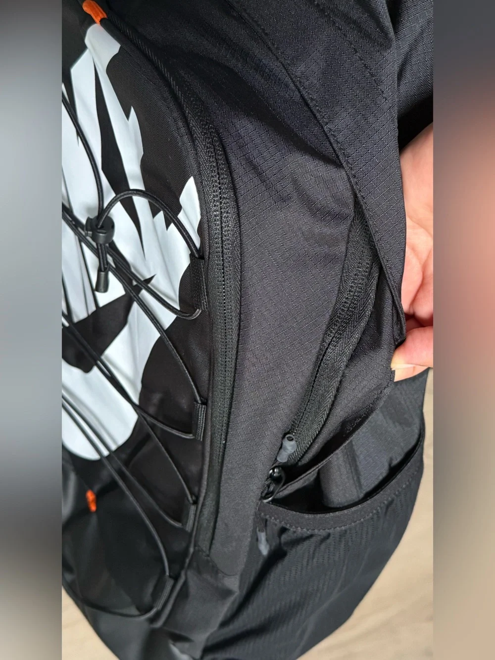 Nike Black Backpack with White Swoosh and Orange Accents